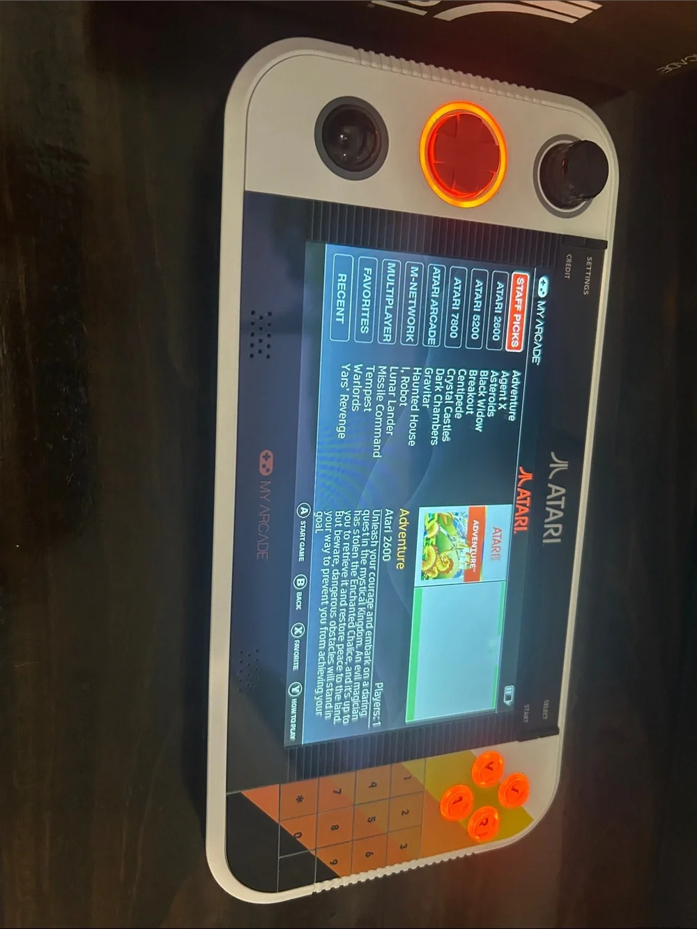 Atari Handheld Gaming Console in White and Orange